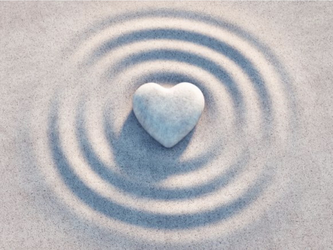 RE:ME Repair — blue heart-shaped stone in rippled sand